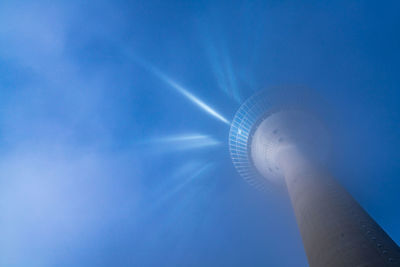 Low angle view of communications tower against sky