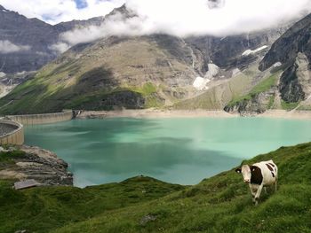 Calm lake against mountain range