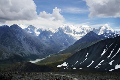 Top view from the pass to the mountain gorge and mount belukha in the snow in summer