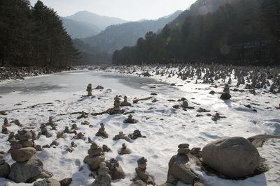 Scenic view of snow by mountain against sky