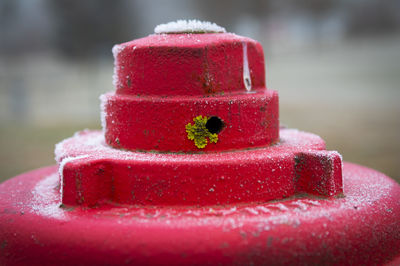 Close-up of red toys on rusty metal
