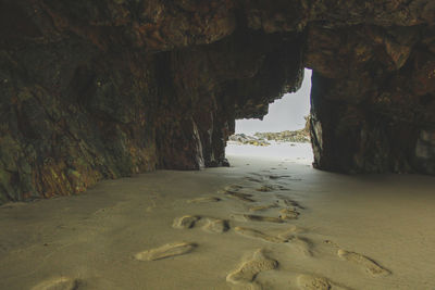 Scenic view of sea seen through cave