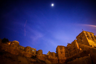 Panoramic view of buildings against sky at night