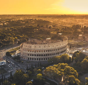 High angle view of coliseum during sunset in city