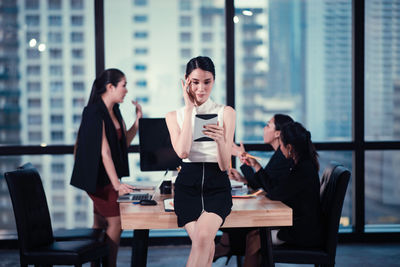 Woman using smart phone on table