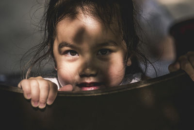 Close-up portrait of cute girl playing outdoors