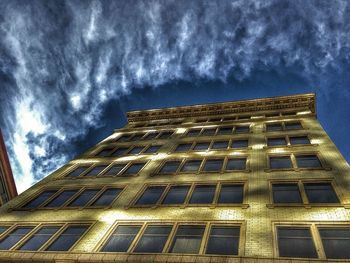 Low angle view of building against cloudy sky