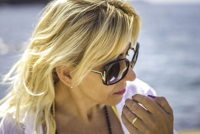 Close-up portrait of young woman wearing sunglasses