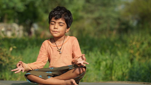 Girl is doing yoga in clean and green environment and fresh air. healthy life style concept.