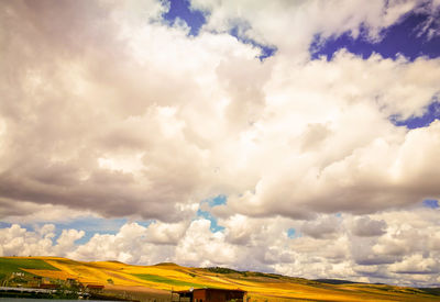 Scenic view of landscape against cloudy sky