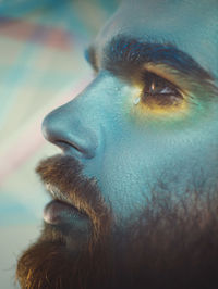 Close-up of serious man with painted face