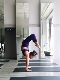 Full length of woman exercising in gym