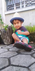 Portrait of smiling boy sitting outdoors