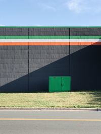 Road by building against clear sky