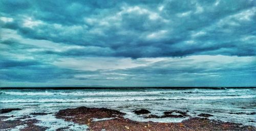 Scenic view of sea against cloudy sky