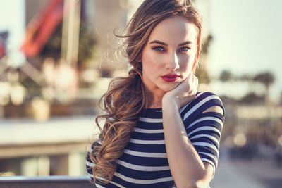 Portrait of beautiful young woman standing outdoors