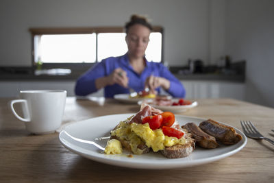 First person view of eating breakfast with someone