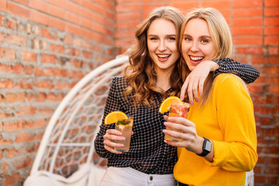 Portrait of a smiling young woman holding food