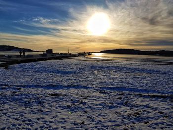 Scenic view of frozen sea against sky during sunset