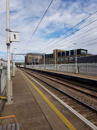 Train at railroad station against sky