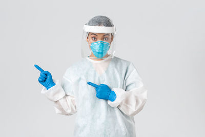 Portrait of person wearing mask against white background