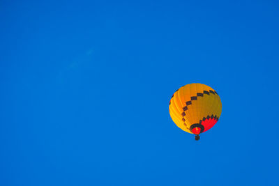 Low angle view of hot air balloon in blue sky