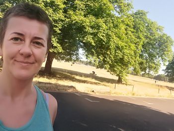 Portrait of smiling woman on road