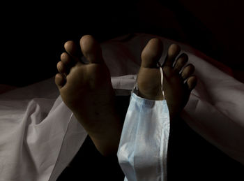 Close-up of person hand on bed