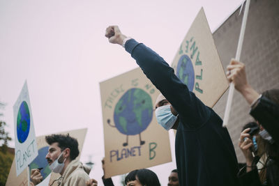 Male activist protesting for environmental issues during pandemic