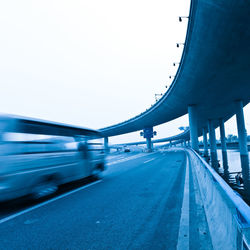 Bridge over road against sky in city