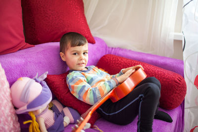 High angle view of baby relaxing on bed at home