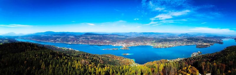 Panoramic view of lake and mountains against blue sky