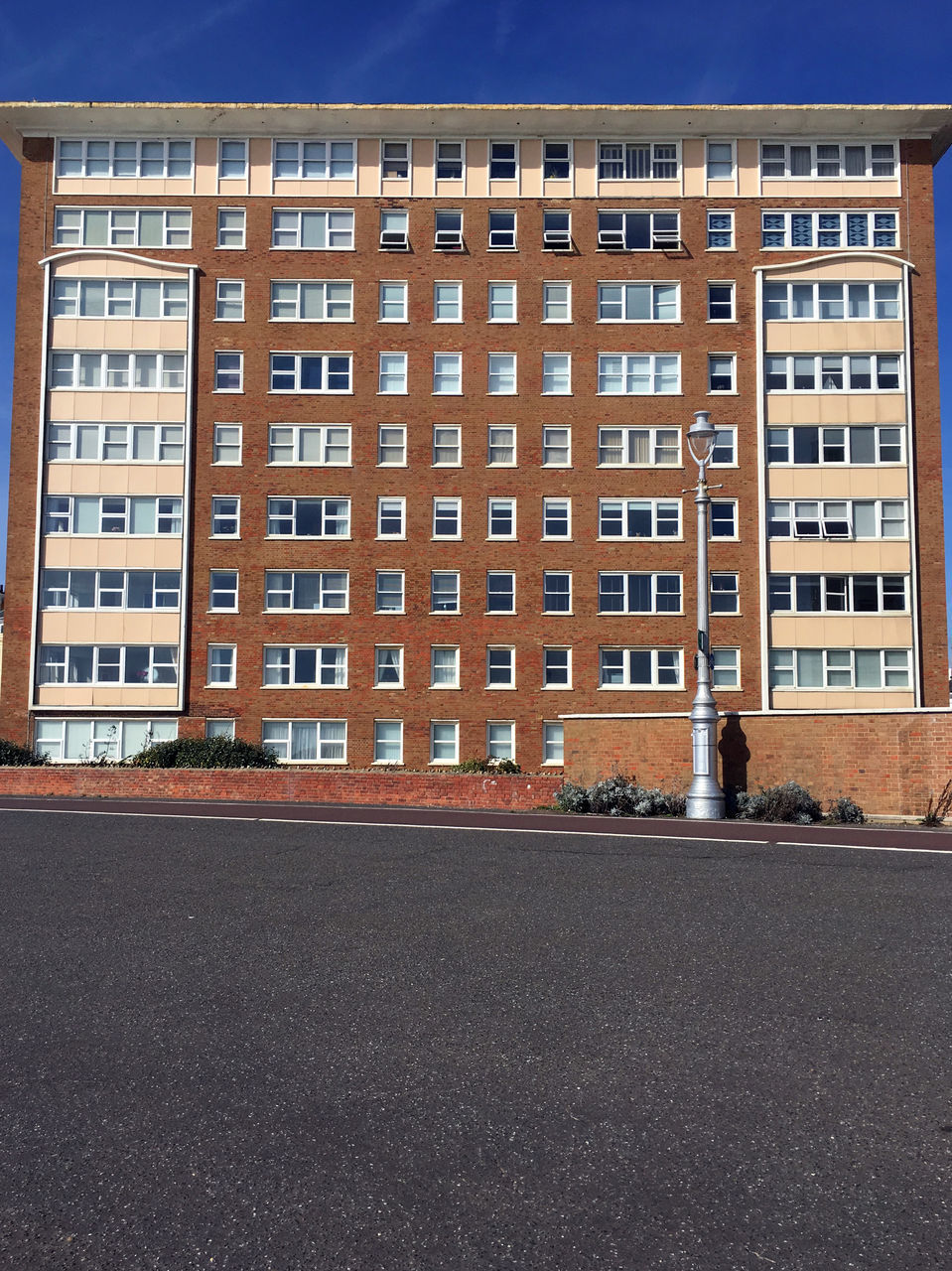 ROAD BY BUILDING AGAINST SKY