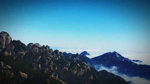 Scenic view of snowcapped mountain against clear blue sky