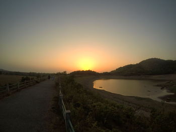 Scenic view of landscape against clear sky during sunset