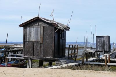 Built structure on beach against sky