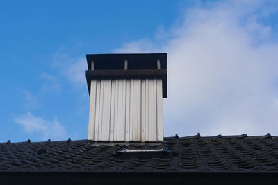 Low angle view of building against cloudy sky