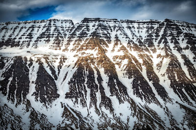 Low angle view of snow on mountain against sky