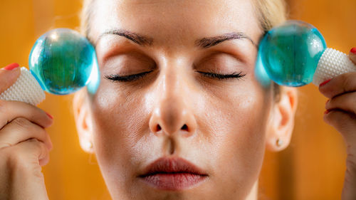 Woman doing facial self-massage with ice balls