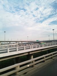 Train on road by sea against sky