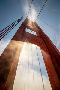 View of one of the foggy red columns of the san francisco bridge.