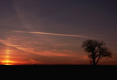 Scenic view of silhouette landscape against orange sky