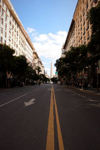 Surface level of road amidst buildings against sky