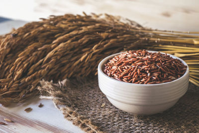 Close-up of brown rice and stalks on table