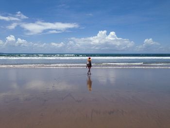 Man on beach against sky