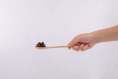 Close-up of hand against white background