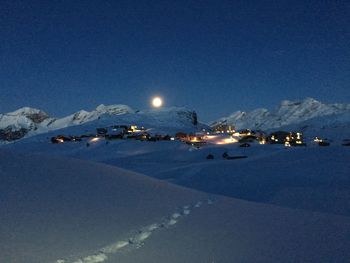 Scenic view of illuminated mountains against sky at night