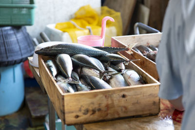 Midsection of man working at market stall