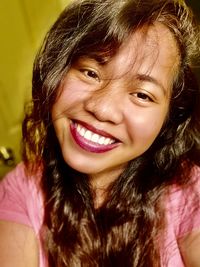 Close-up portrait of a smiling young woman