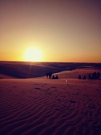 Scenic view of desert against sky during sunset